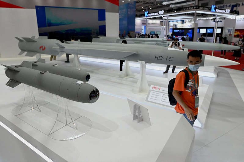 © AFP via Getty Images File. A man walks among supersonic cruise missiles at the 13th China International Aviation and Aerospace Exhibition in Zhuhai