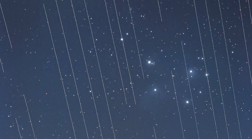 Streaks from satellites cross the Pleiades on a long-duration exposure, illustration the interference the growing number of satellites can have on astronomy. Credit: T. Hansen/IAU OAE/CC